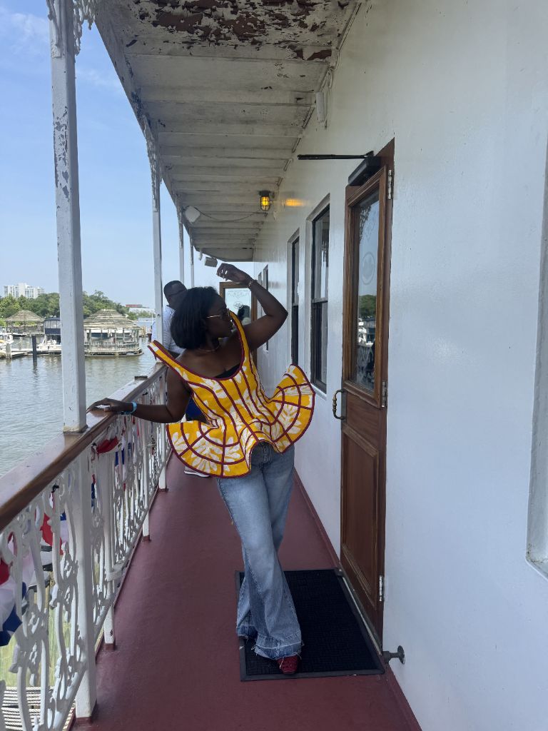 A mustard Ankara one-shoulder peplum top, made by Minnie